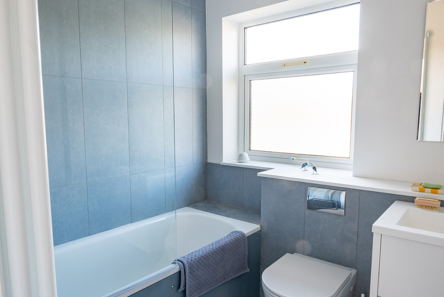 Modern bathroom with soft blue tiling