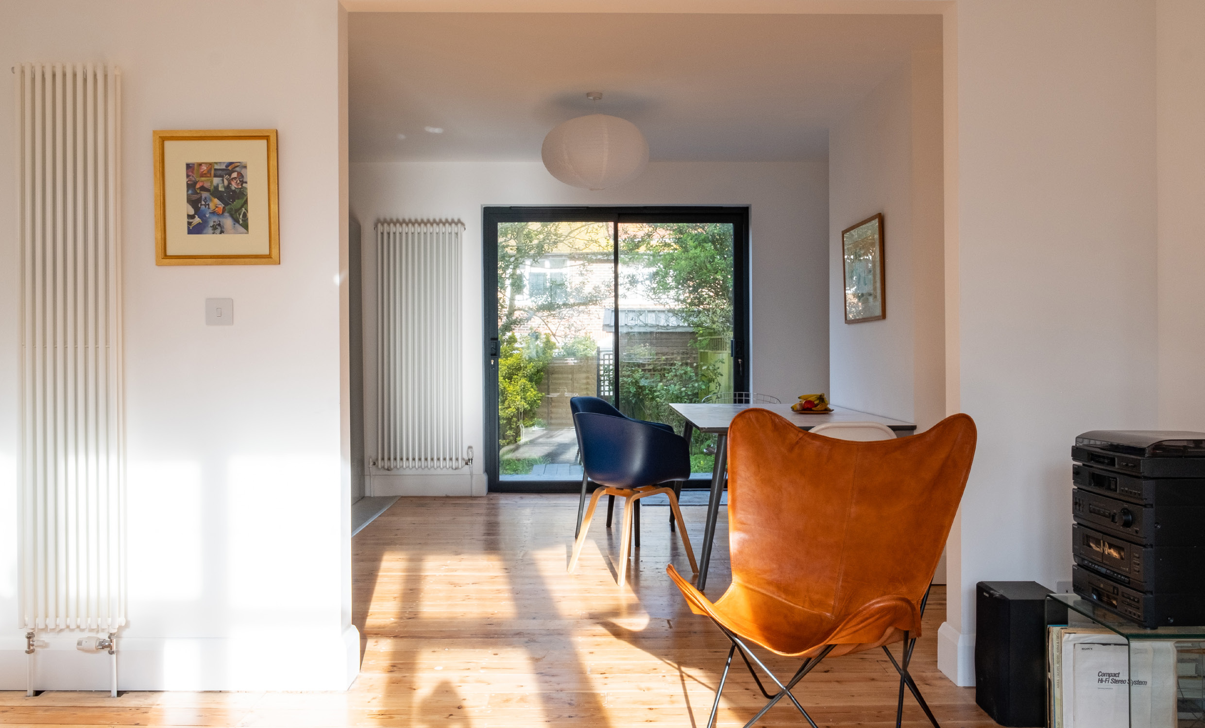 Sunlit open-plan dining room with garden doors